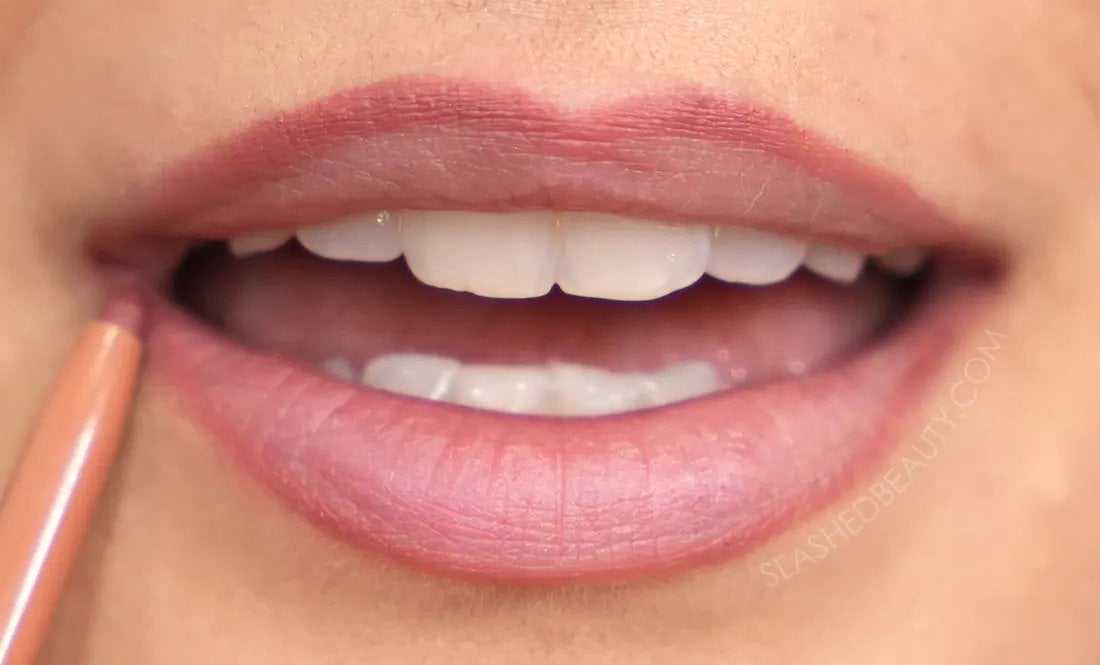 how-to-line-lips-bigger-4 | Slashed Beauty Close up of lips with lip liner drawn on the top and bottom lip edges. | How to Make Your Lips Look Bigger with Makeup | Slashed Beauty