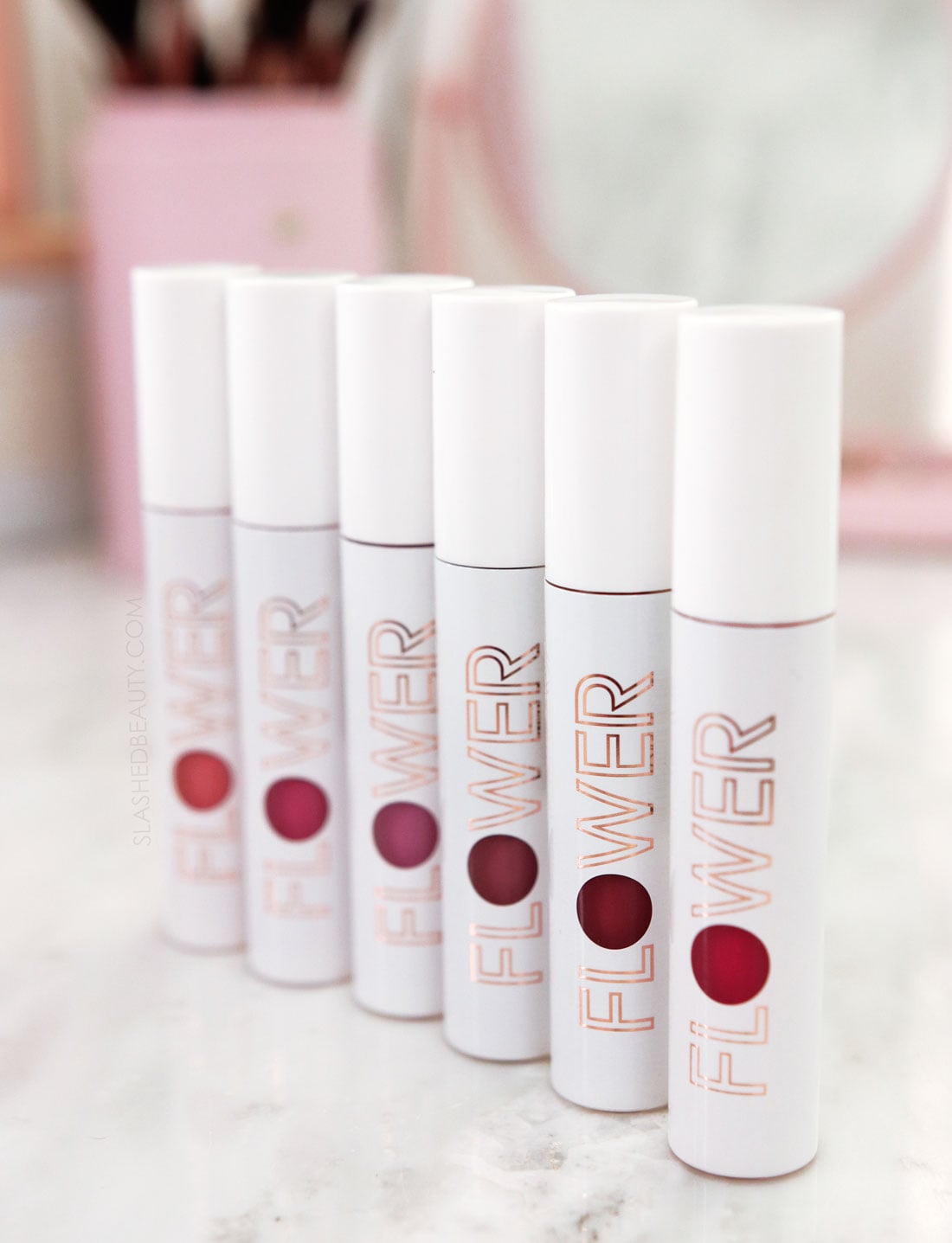 flower-beauty-bitten-stains | Slashed Beauty Closed tubes of Flower Beauty Bitten Lip Stain standing side by side on a vanity | Flower Beauty Bitten Lip Stains Review & Swatches | Slashed Beauty