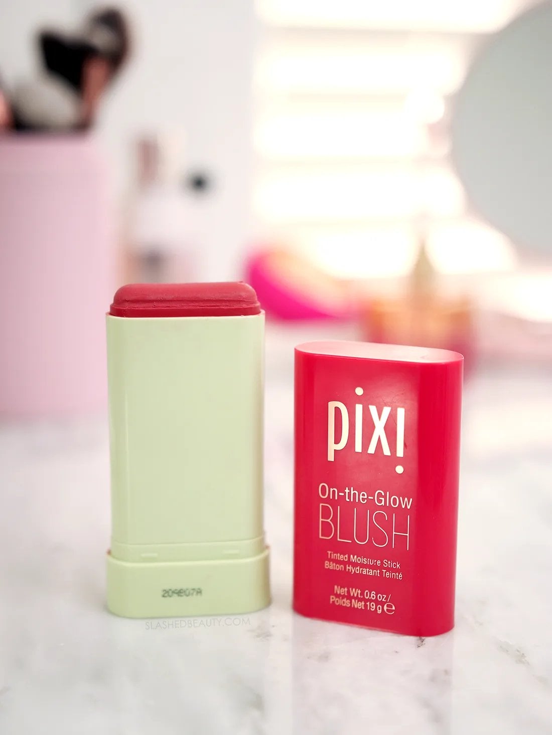 PIXI-on-the-glow-blush-stick-review | Slashed Beauty Pixi On-the-Glow Blush Stick open on a marble surface | Pixi On-the-Glow Blush Review | Slashed Beauty