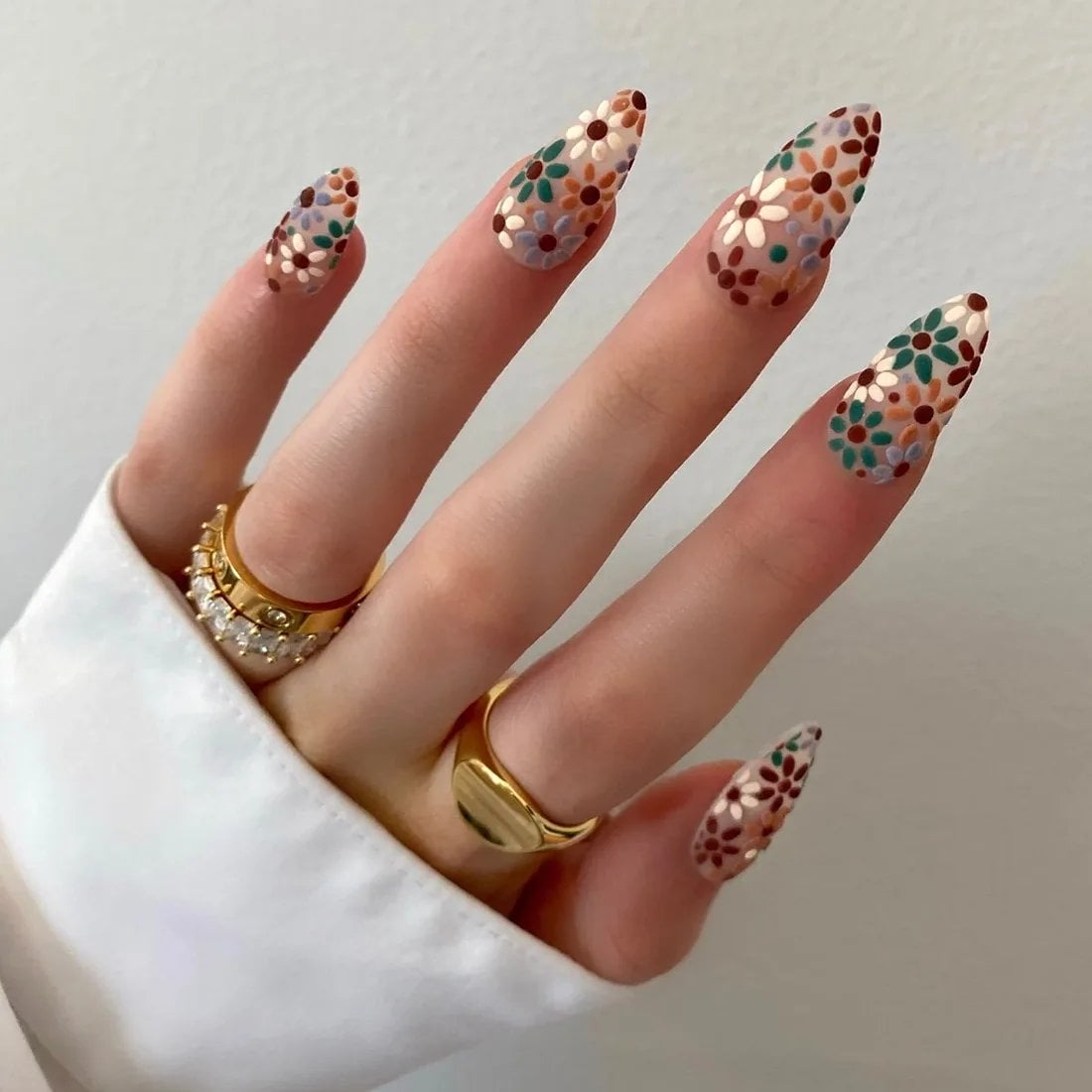 fall-flower-nails-press-on | Slashed Beauty Sheer nails with fall flowers painted in blue, green, orange, burgundy and white | Trendy Fall Nail Designs You Can Buy as Press-Ons on Etsy | Slashed Beauty
