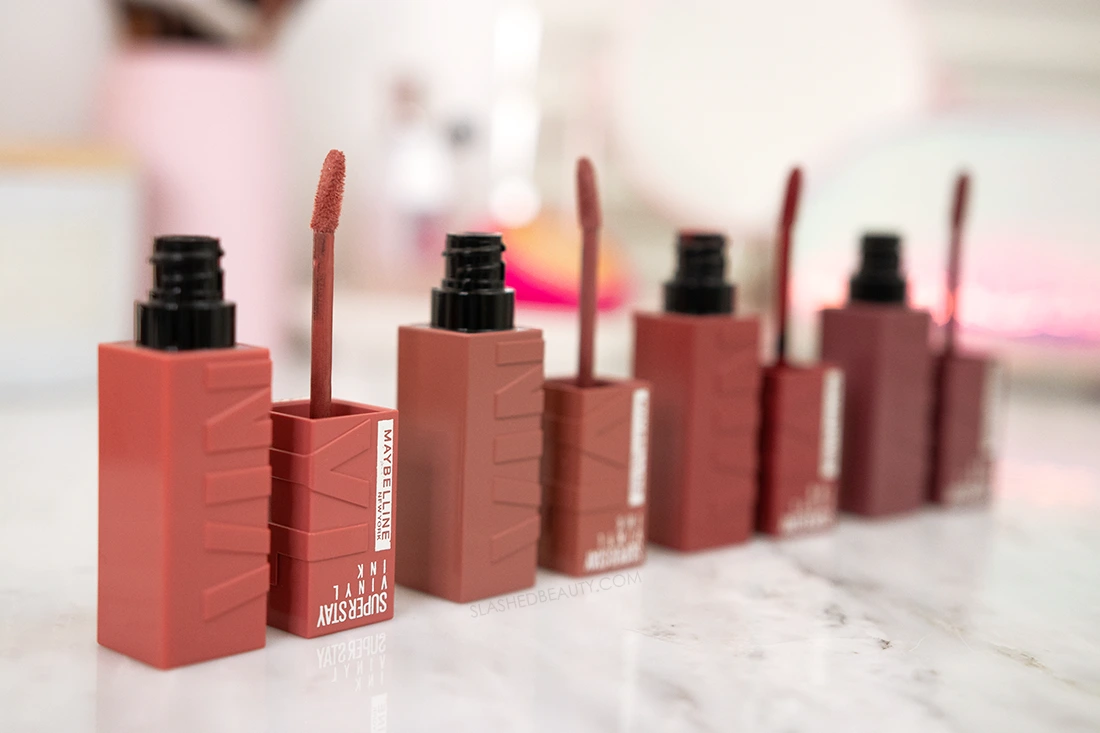 maybelline-superstay-vinyl-ink-review | Slashed Beauty Open tubes of Maybelline Superstay Vinyl Ink Liquid Lipstick on a marble surface | Maybelline Superstay Vinyl Ink Liquid Lipsticks Review | Slashed Beauty