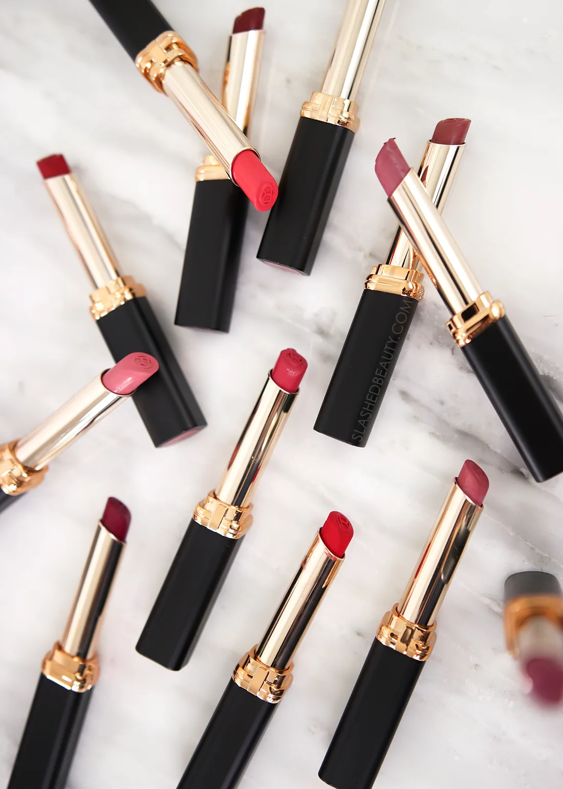 loreal-intense-volume-matte-lipstick | Slashed Beauty Various shades of L'Oreal Colour Riche Intense Volume Matte Lipsticks lying on a marble surface. | L'Oreal Colour Riche Matte Lipsticks Review & Swatches | Slashed Beauty