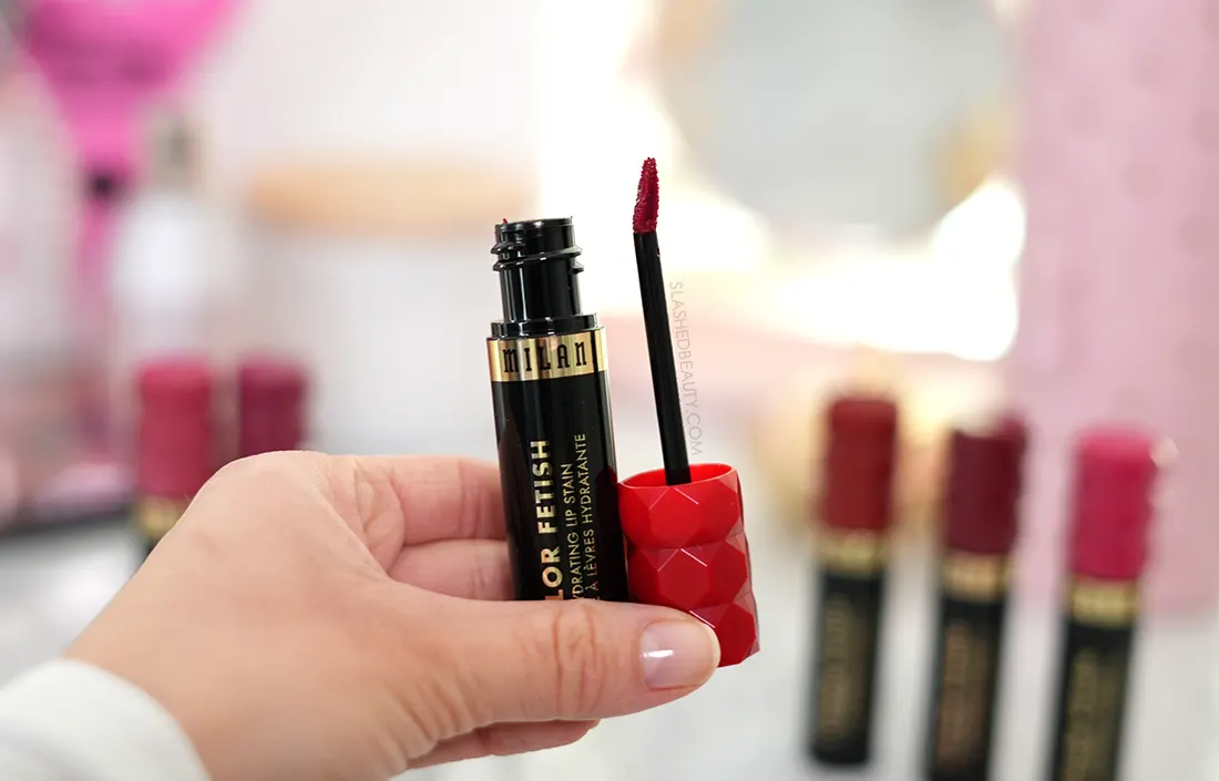 milani-lip-stain | Slashed Beauty Hand holding open tube of Milani Color Fetish Hydrating Lip Stain | Review & Swatches | Slashed Beauty