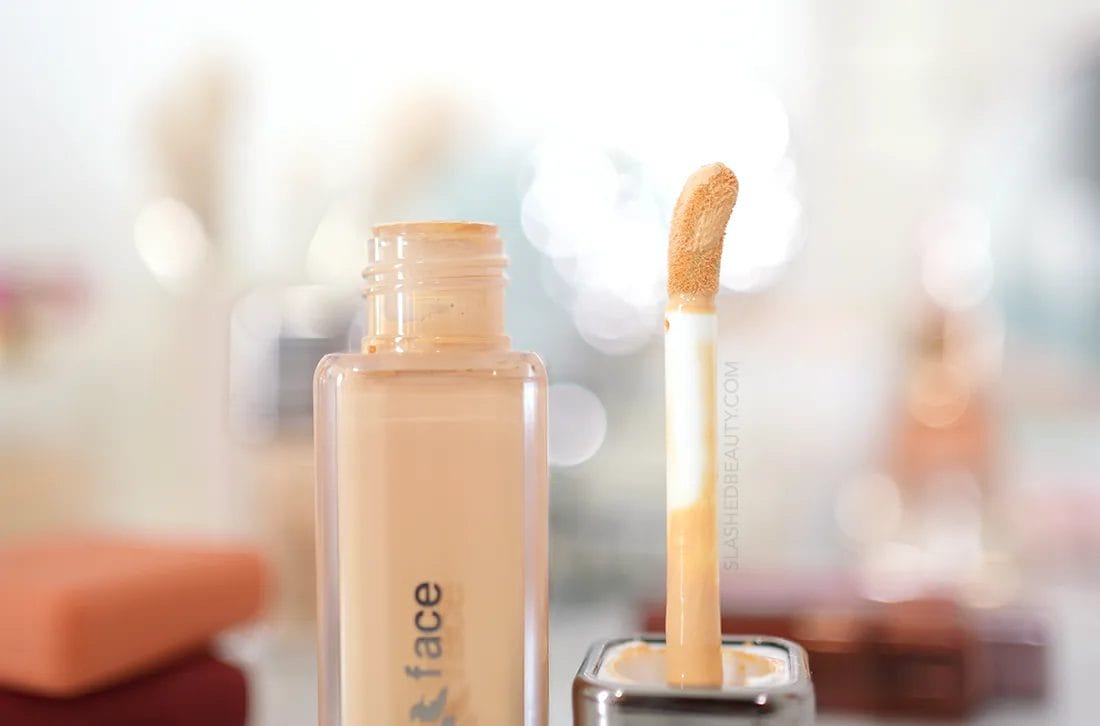 ABOUT-face-appliator | Slashed Beauty Close up of about-face The Performer Skin Focused Foundation open bottle and applicator. | about-face Foundation Review | Slashed Beauty