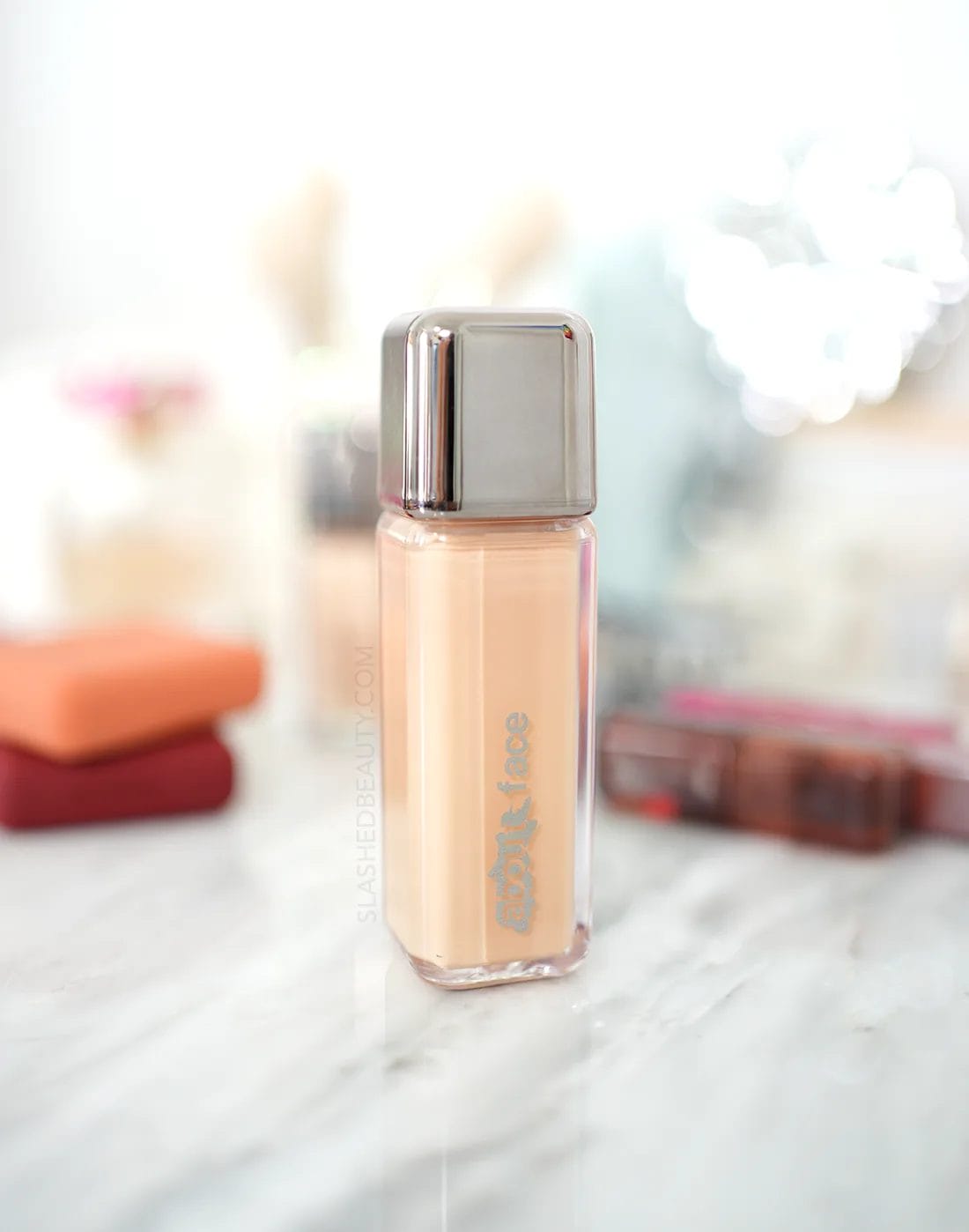 abouut-face-performer-foundation | Slashed Beauty Closed bottle of about-face The Performer Skin Focused Foundation on a marble vanity among other beauty products. | about-face Foundation Review | Slashed Beauty