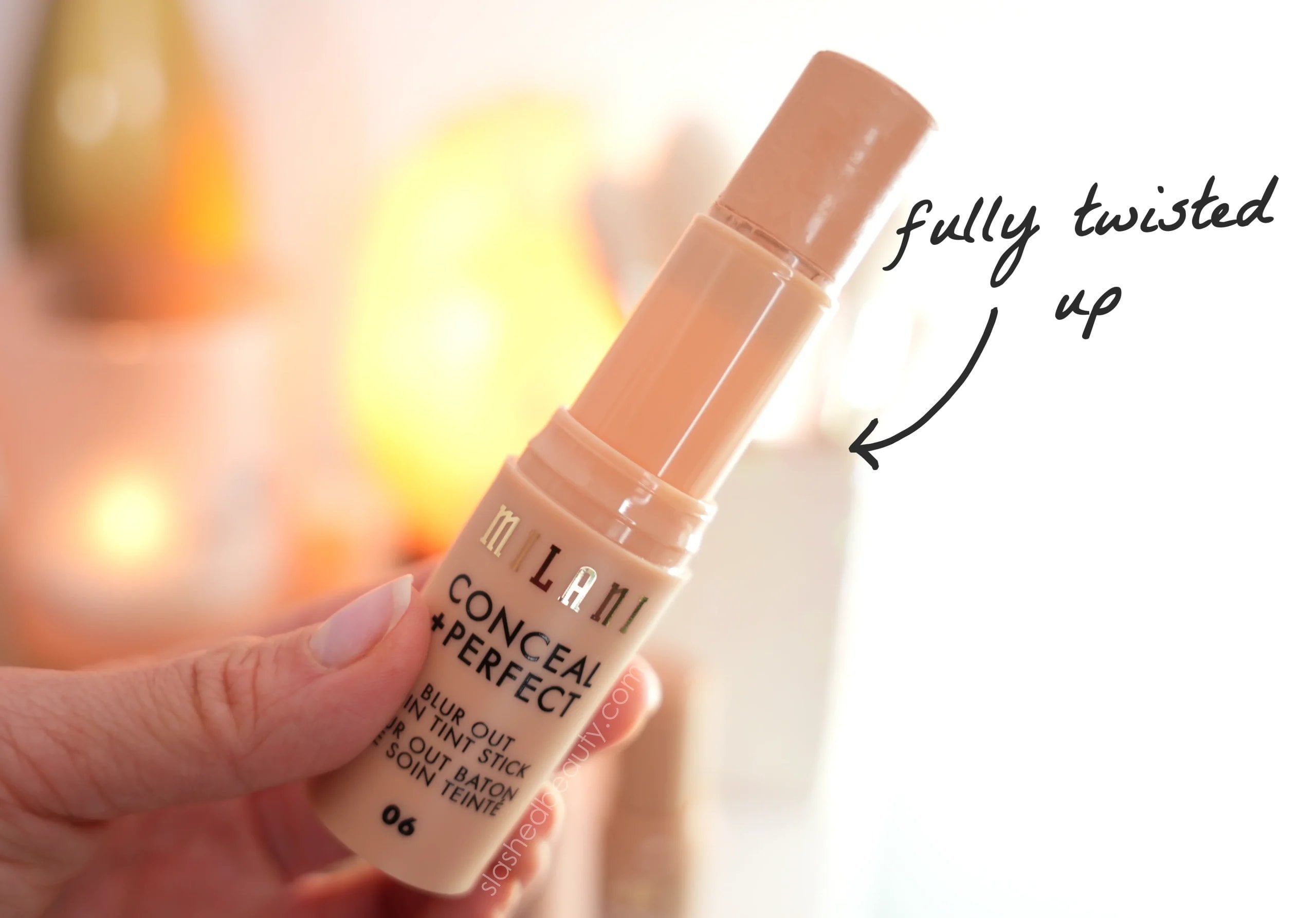 milani-tint-stick-amount-of-product | Slashed Beauty Holding a tube of Milani Conceal + Perfect Blur Out Skin Tint Stick twisted all the way up to show amount of product. | Milani Blur Out Skin Tint Stick Review | Slashed Beauty